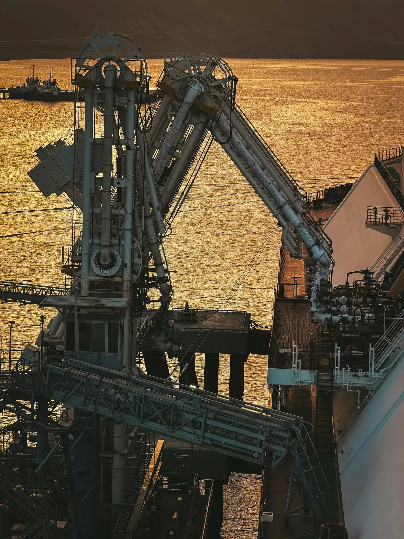 Bulk material loading equipment at a port at sunset